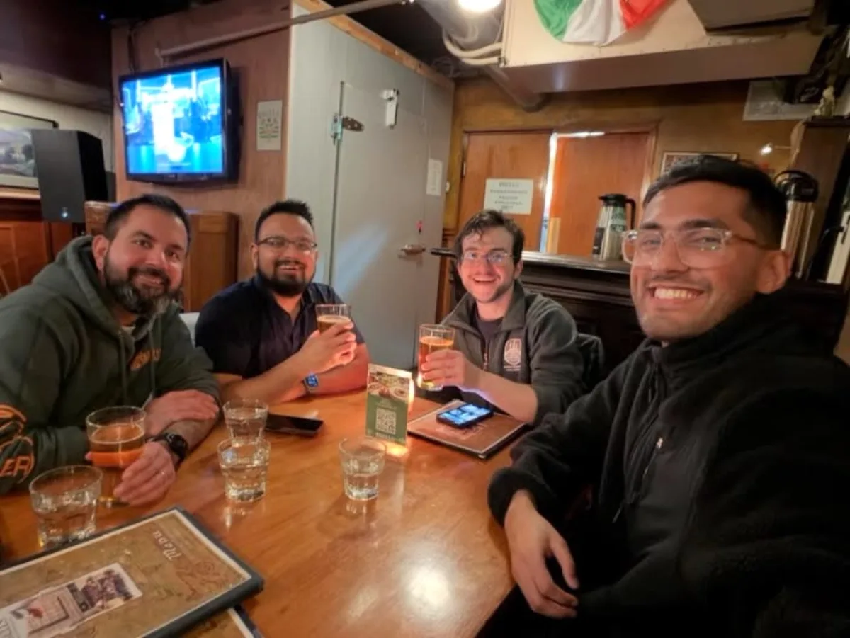 Four members sharing beers at a Seattle pub